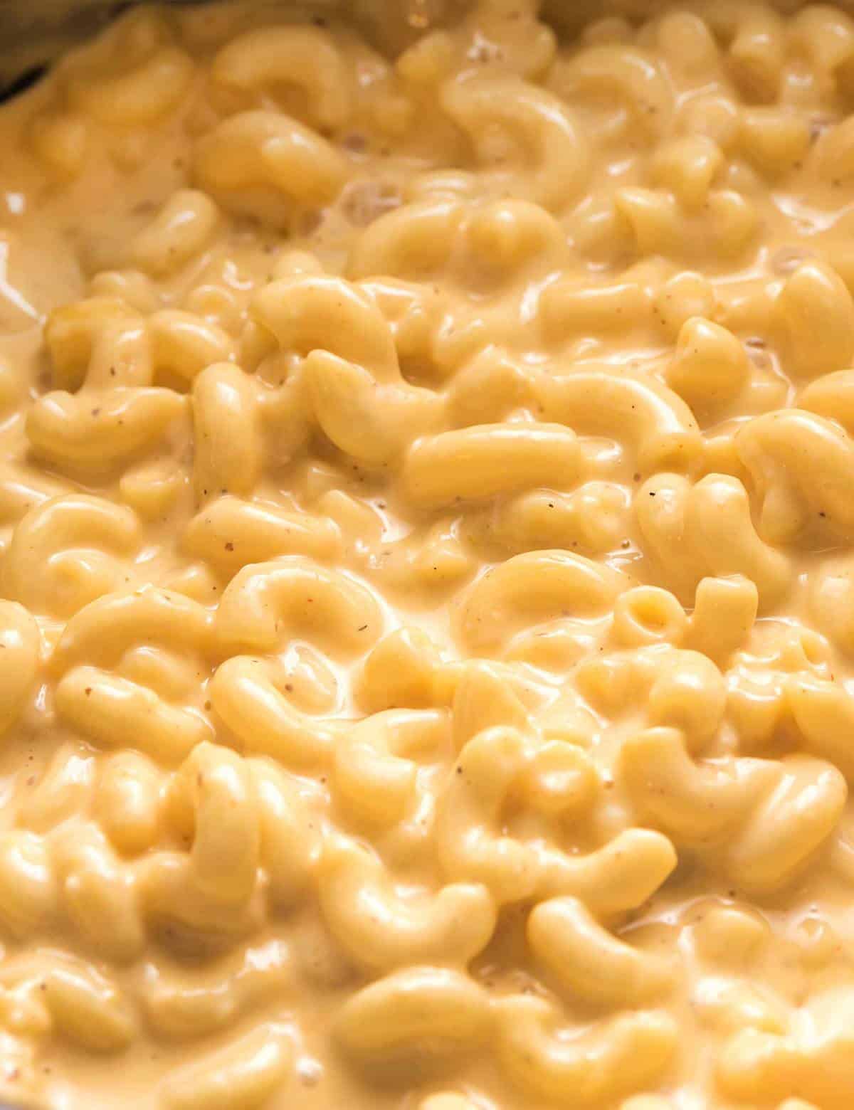 This ultra creamy Mac and Cheese recipe is made right in your slow cooker! Loved by both kids and adults, it's perfect for parties, potlucks, and more! #macandcheese #crockpot #slowcooker