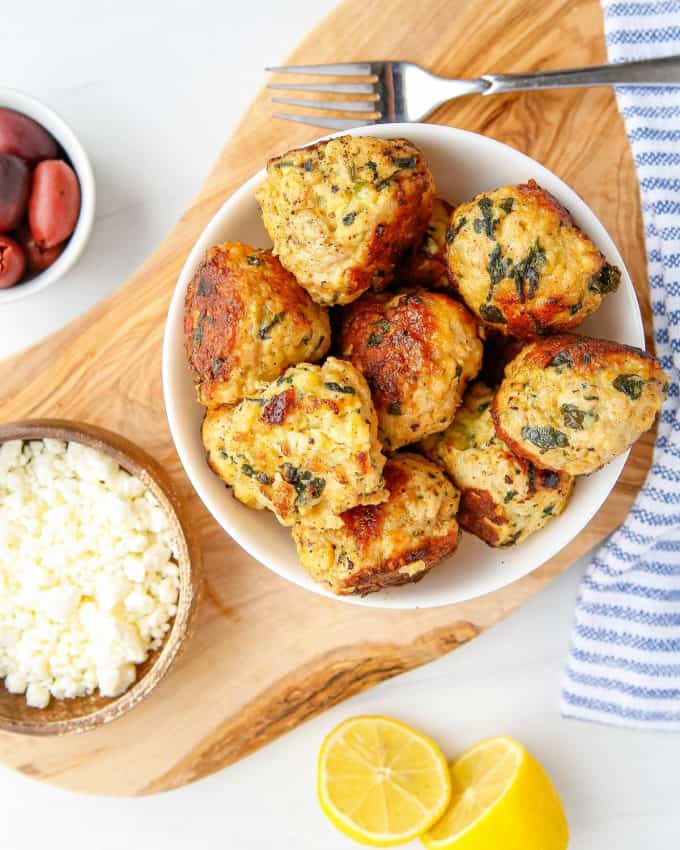 Juicy and full of amazing flavor, these Spinach and Feta Turkey Meatballs are perfect for a quick weeknight dinner, a fun appetizer, or meal-prepping for lunches! Easily made in the Instant Pot, oven or on the stovetop, you'll love the succulent texture. #meatballs #feta #turkey #greek