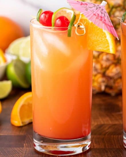 With just one sip, this Tropical Rum Punch will make you feel like you're on an island vacation! Easy to make just a single drink, or scale it up for a party! #punch #rum #cocktail