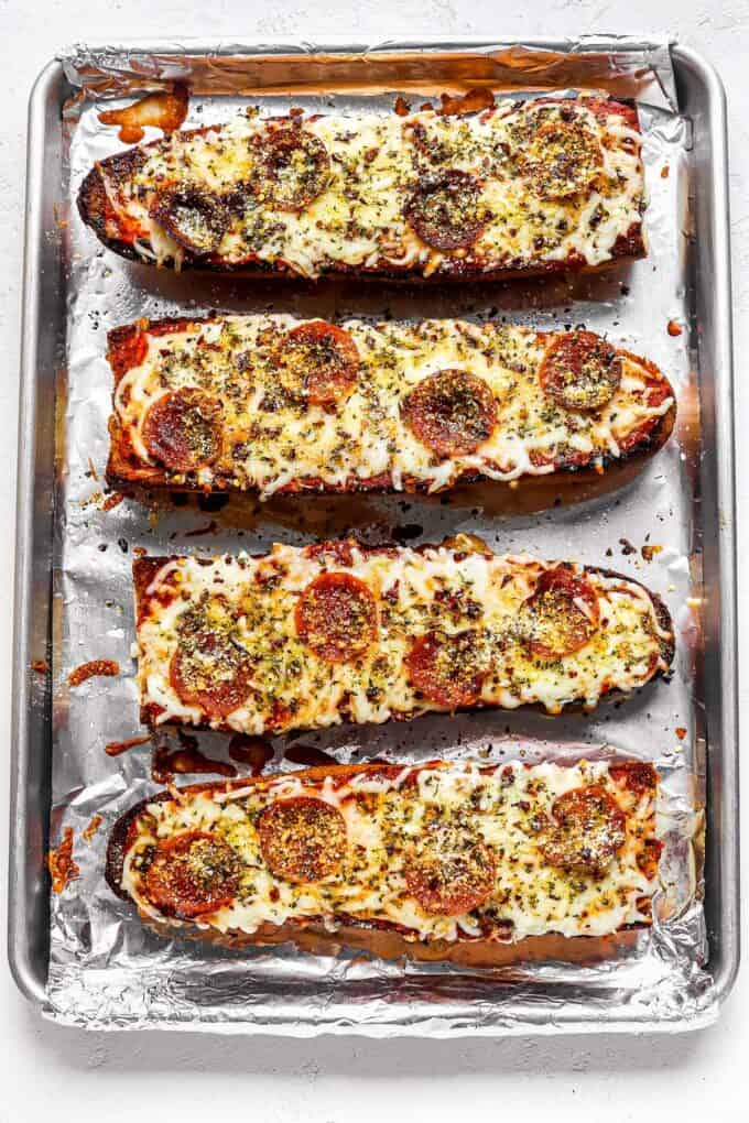 french bread pizzas on baking sheet