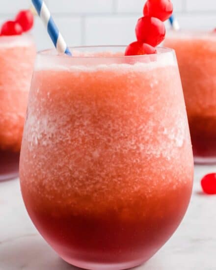 This Cherry Cola Bourbon Slush is our favorite frozen cocktail! Made with just 4 ingredients (including ice!), it's so easy to whip together and enjoy all year round! #slush #bourbon #cherry