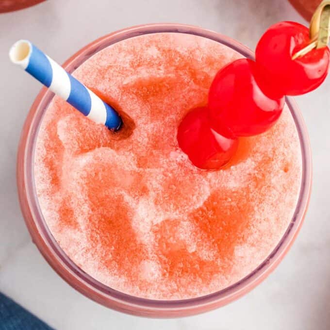overhead view of a bourbon slush with cherries