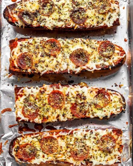 This recipe for French Bread Pizza is so easy to make, and so much better than anything from the frozen food aisle! French bread is brushed with garlic butter and toasted, then topped with all your favorite pizza toppings and baked again. #frenchbread #pizza #dinner