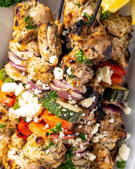 Juicy chicken thighs marinated in an ultra flavorful lemon and herb yogurt sauce, skewered with veggies and grilled to perfection. Perfect for summer, but recipe has alternative cooking methods for winter too! #chicken #greek #kebabs