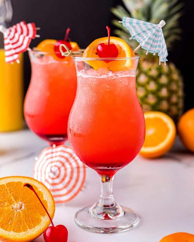 With just one sip, this Hurricane Cocktail will make you feel like you’re on an island vacation! Easy to make just a single drink, or scale it up for a party! #rum #cocktail #drink