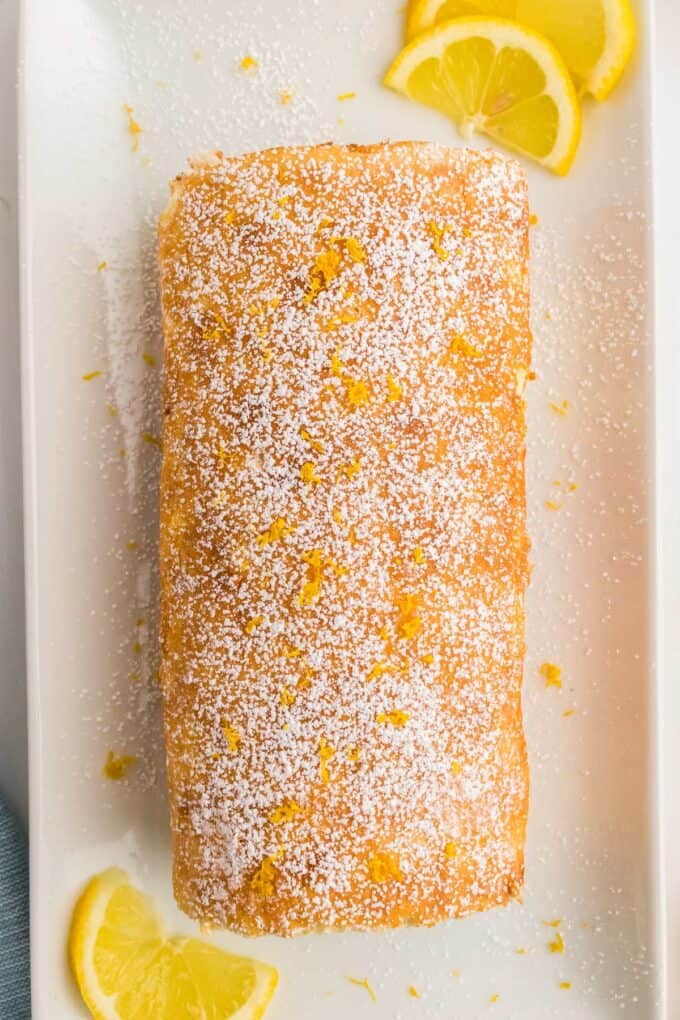 lemon roll cake on white platter