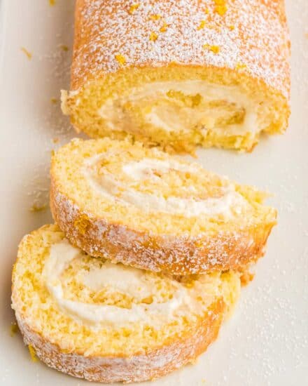 This Lemon Cake Roll is bursting with lemon flavor, ultra moist, and filled with an amazing lemon whipped cream filling. Looks fancy and complicated, yet is pretty easy to make! #cakeroll #lemon #rollcake