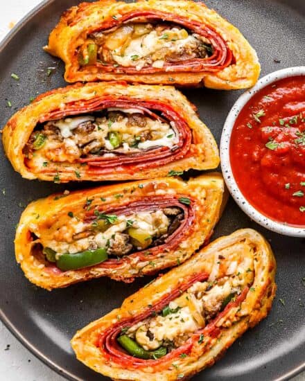 This Stromboli is loaded with Italian meats, cheeses and vegetables, and all wrapped up in a crispy cheesy crust. Like a deluxe pizza, all rolled up like a burrito. Great for a busy weeknight when you use store bought pizza dough! #pizza #stromboli #italian