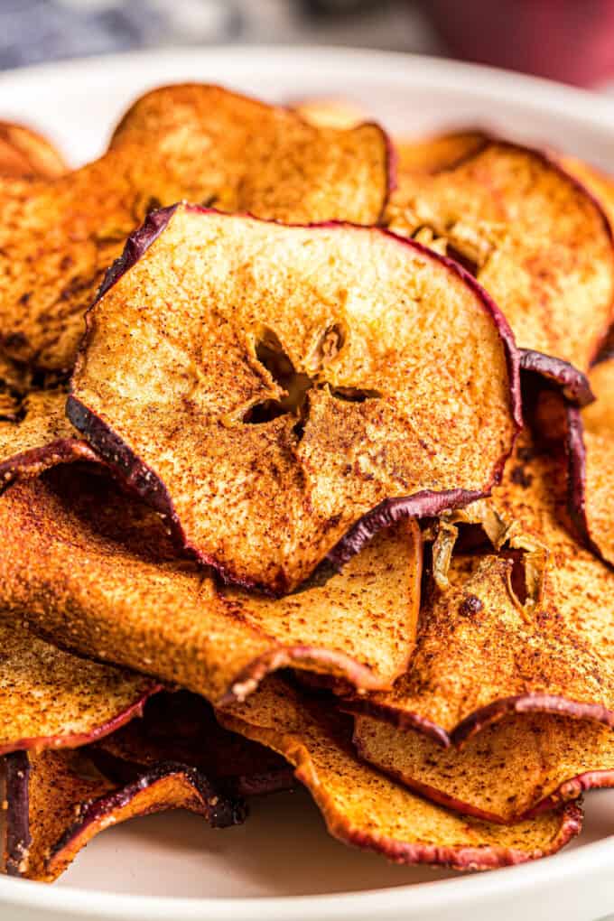 These Cinnamon Apple Chips are a healthy and delicious snack, made easily in the air fryer! Great way to use Fall apples, and this recipe is a family favorite! #applechips #fall #airfryer