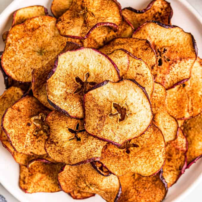 pile of apple chips on white plate
