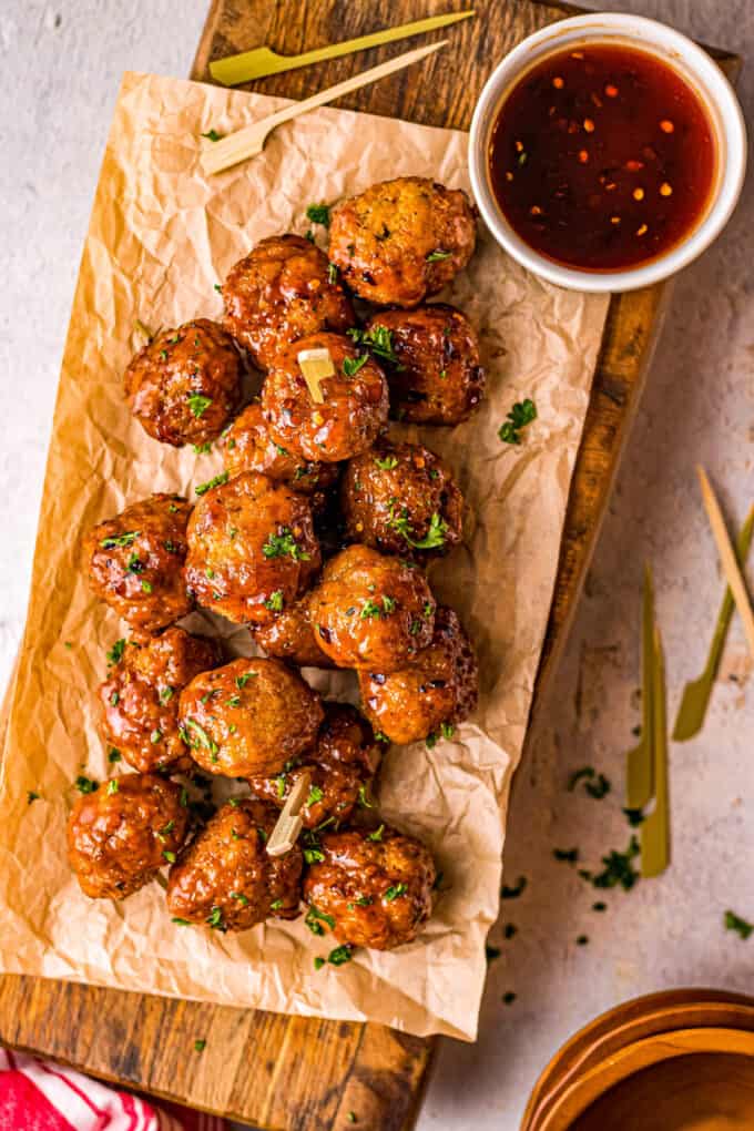 No more boring chicken meatballs! These Firecracker Chicken Meatballs are delicious on their own, but SO much better with the sweet, savory and spicy firecracker sauce! Perfect for a party or fun dinner! #appetizer #meatballs #firecracker #airfryer