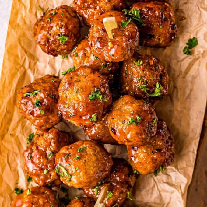 pile of chicken meatballs on parchment paper with firecracker sauce
