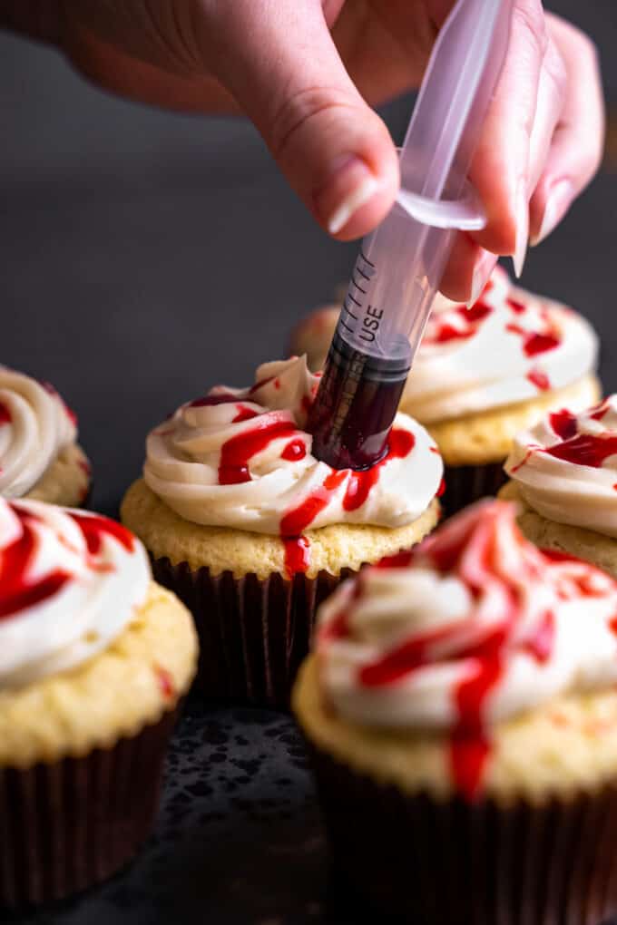 syringe of edible blood pushed into halloween cucpake