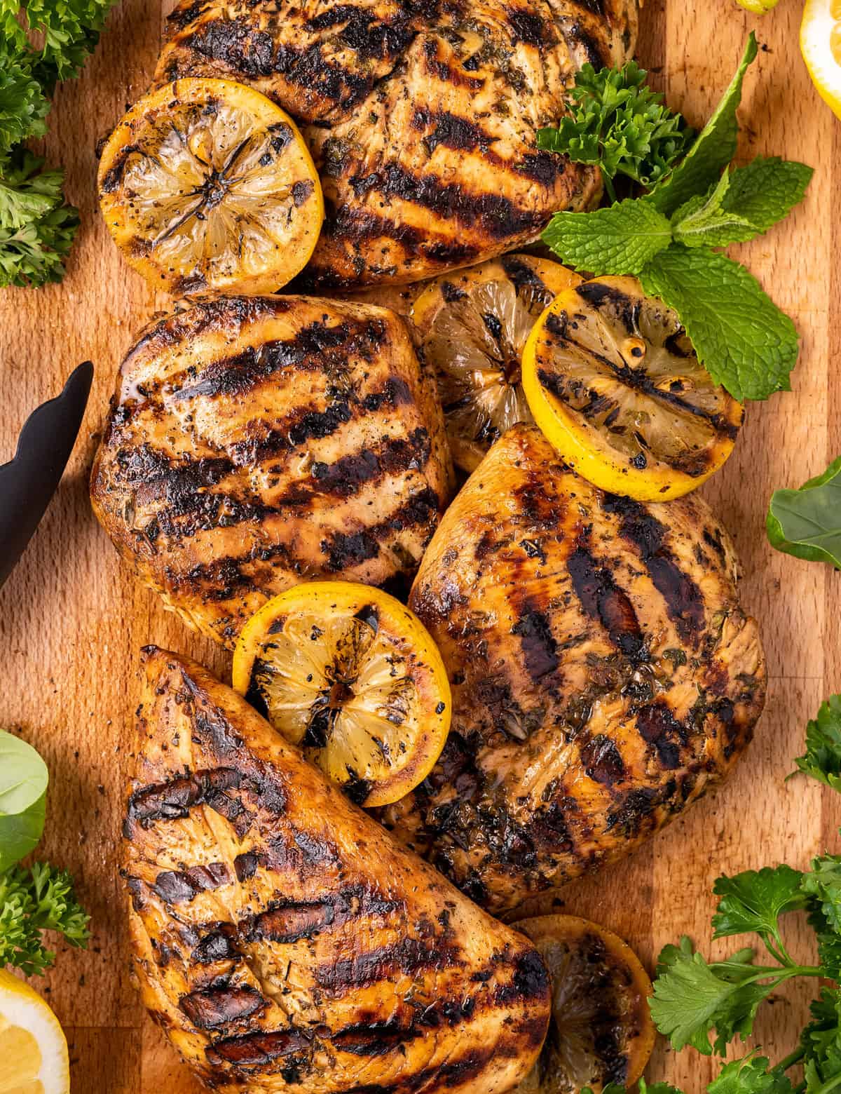 This Lemon Herb Grilled Chicken is juicy and beautifully charred. The easy marinade is perfect for not only chicken, but pork and seafood too. It's a great versatile chicken recipe! #grilled #chicken #lemon