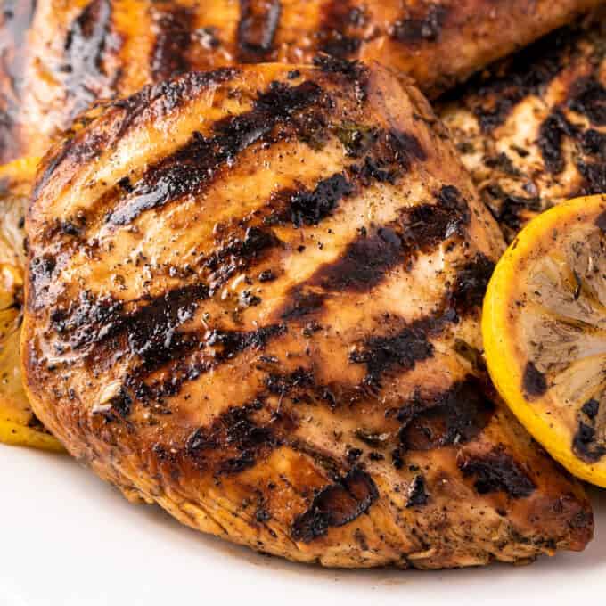 pile of grilled chicken on white plate