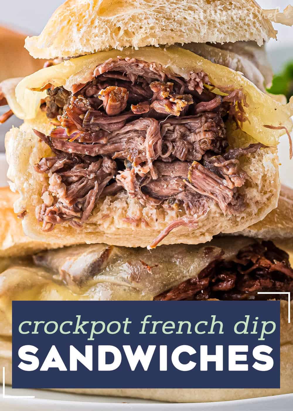 These Slow Cooker French Dip Sandwiches are made with ultra tender roasted beef, melted provolone cheese, soft hoagie bread, and dipped into an amazing au jus sauce. Perfect cold weather comfort food for the whole family! #frenchdip #sandwich #slowcooker #crockpot