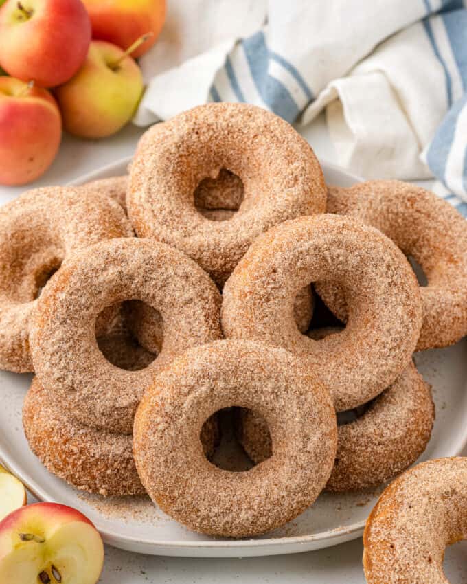 pile of baked apple cider donuts on white plate