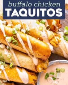 These Buffalo Chicken Taquitos are the perfect crowd-pleasing appetizer! Cheesy buffalo chicken filling is rolled up in flour tortillas and baked until crispy. Serve with an easy buffalo ranch and sprinkled with green onions and blue cheese crumbles! #buffalochicken #taquitos #appetizer #partyfood