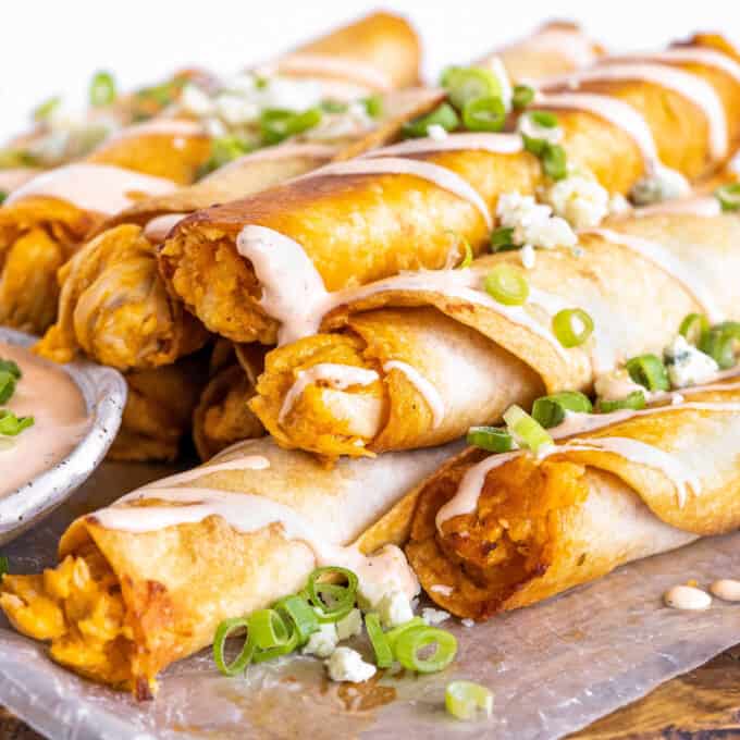 pile of buffalo chicken taquitos drizzled with buffalo ranch