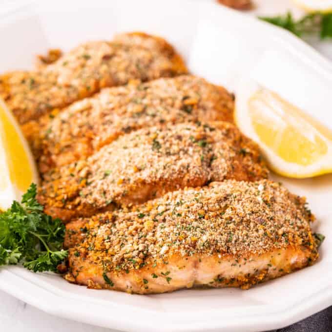 four crusted salmon filets on platter