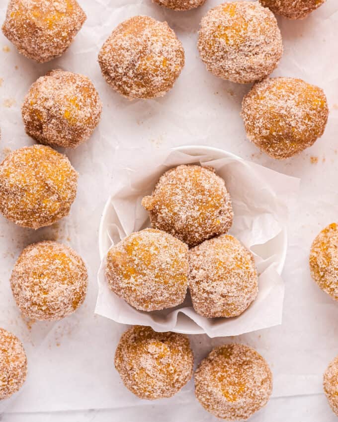 bunch of pumpkin donut holes on counter