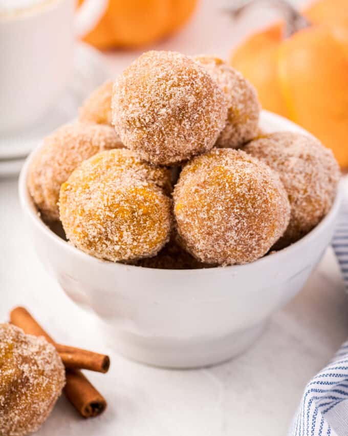 pile of baked donut holes in white bowl