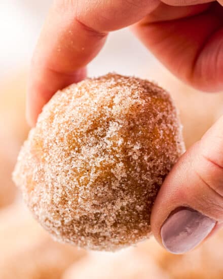 These light and fluffy pumpkin spice donut holes are baked instead of fried, and decadently dipped in butter and rolled in cinnamon sugar. They're the perfect Fall breakfast or treat! #pumpkin #donutholes #pumpkinspice