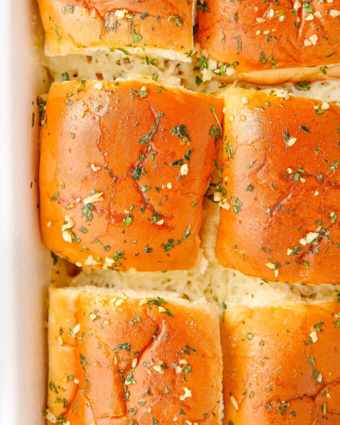 sliders in baking pan with buttered tops