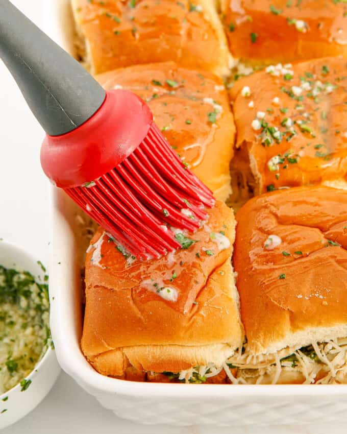 brushing tops of rolls with garlic butter