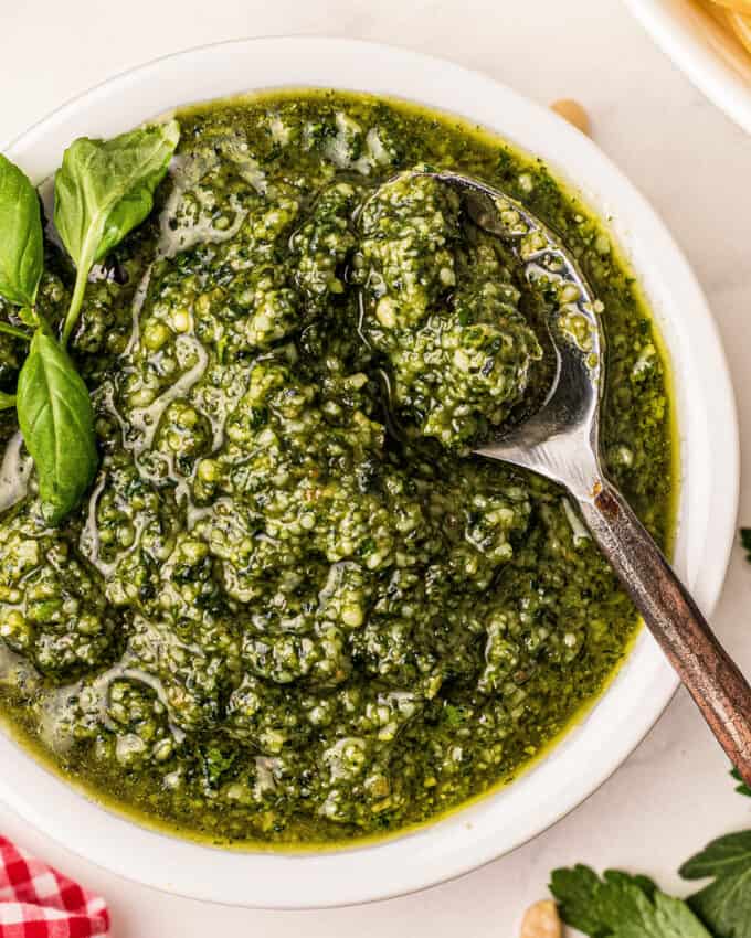 bowl of basil pesto with spoon