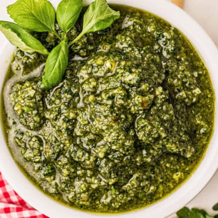 close up of basil pesto in white bowl