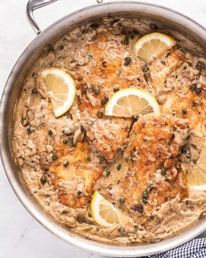 lemon chicken piccata with cream sauce in skillet