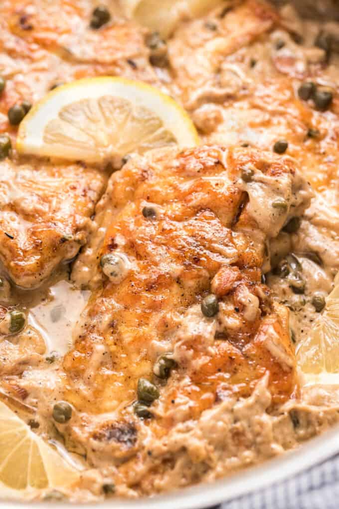 Tender chicken cutlets, lightly breaded and served in a mouthwatering lemon cream sauce with capers and shallots. Great over pasta and ready in about 30 minutes! #piccata #chicken #italian #30minutemeal