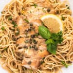 sliced chicken piccata on bed of spaghetti