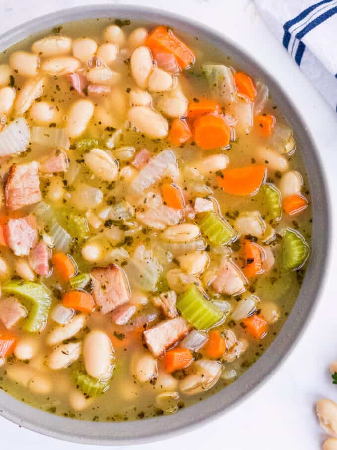 This ultra hearty Ham and Bean Soup is perfect for using up that leftover holiday ham! After all the holiday cooking, you could use something soul-warming and comforting. #soup #ham #beans #holiday