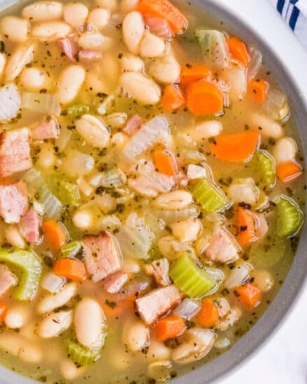 This ultra hearty Ham and Bean Soup is perfect for using up that leftover holiday ham! After all the holiday cooking, you could use something soul-warming and comforting. #soup #ham #beans #holiday