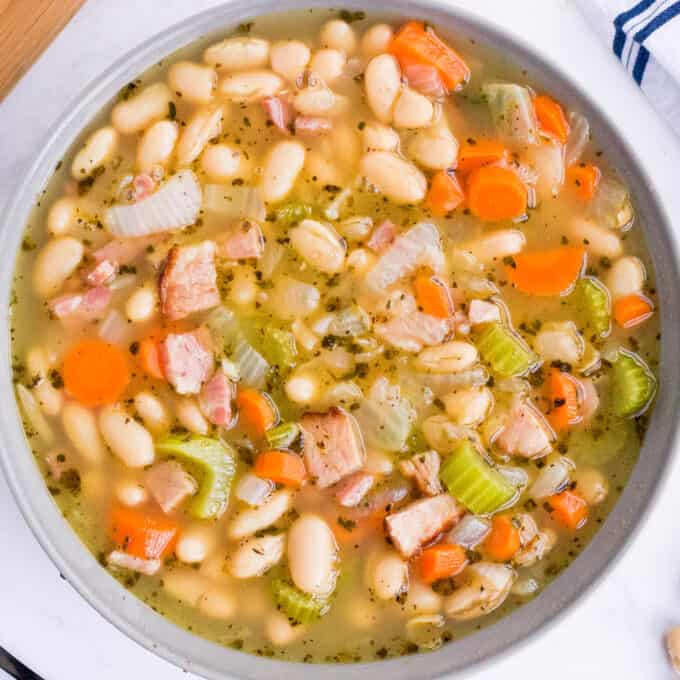 overhead view of ham and bean soup in grey bowl