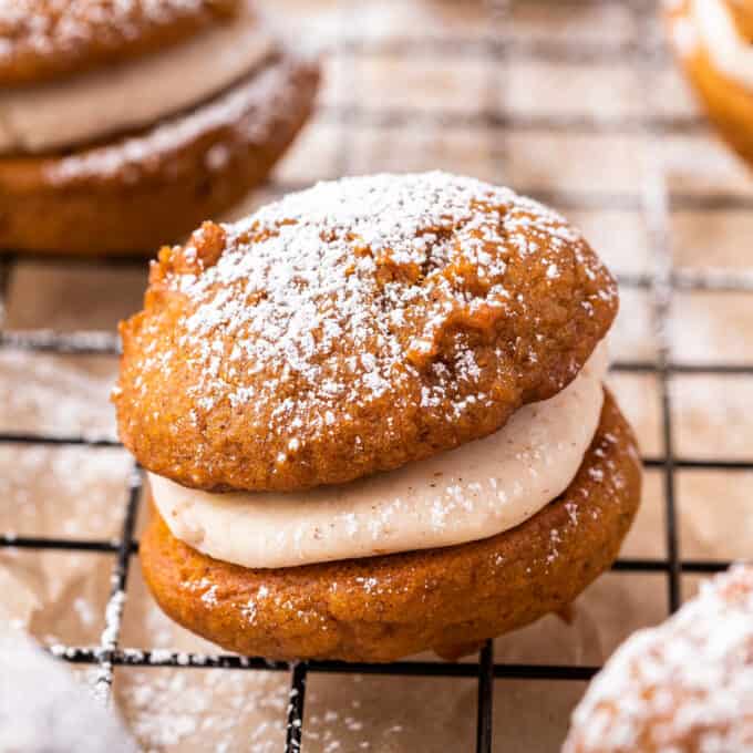 Soft and moist spiced pumpkin cookies sandwiched together with a browned butter maple buttercream that is out of this world delicious! They're the perfect Fall baking treat! #pumpkin #whoopiepies #pumpkinspice