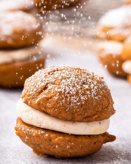 Soft and moist spiced pumpkin cookies sandwiched together with a browned butter maple buttercream that is out of this world delicious! They're the perfect Fall baking treat! #pumpkin #whoopiepies #pumpkinspice