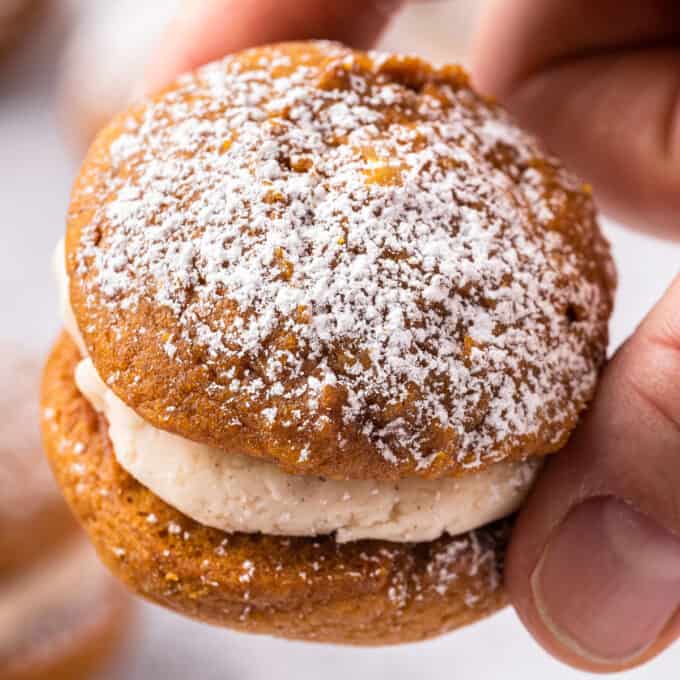 holding a pumpkin spice whoopie pie