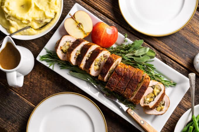 platter of stuffed pork tenderloin on wooden table