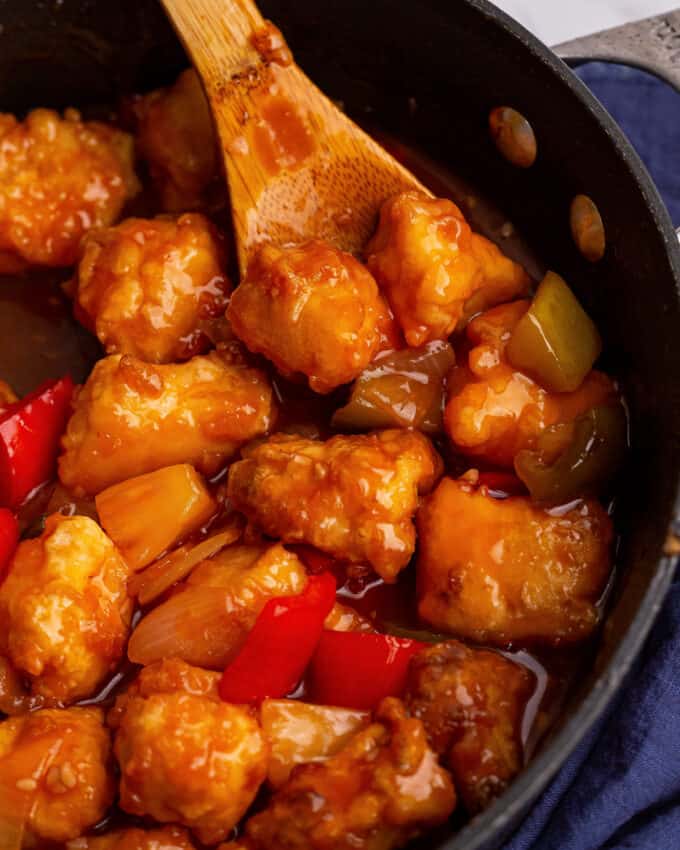 This Sweet and Sour Chicken Skillet is the perfect family dinner! Chicken is fried until crispy, added to a skillet with sautéed bell peppers, onions and pineapple, and tossed in an amazing takeout style sweet and sour sauce! #sweetandsour #chicken #chinese #takeout