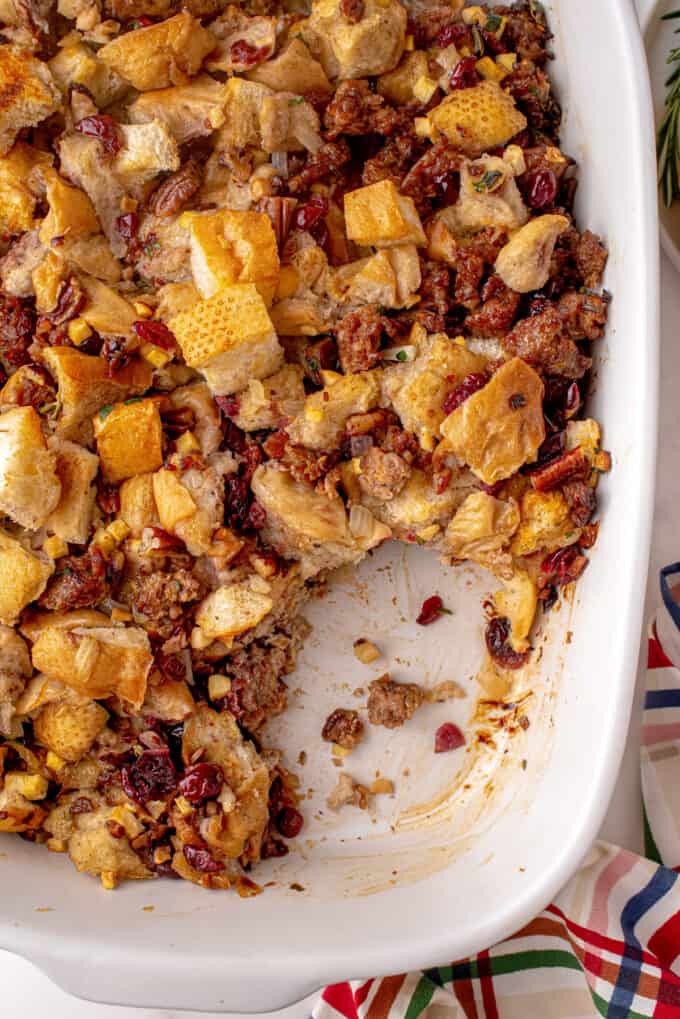 sausage stuffing in baking dish with scoop taken out