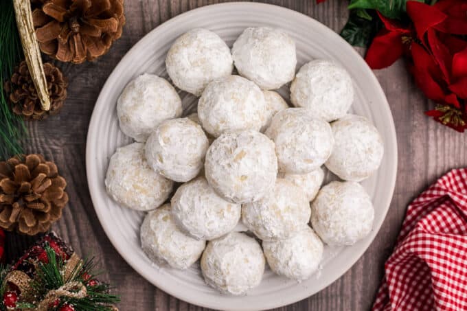 snowball cookies on plate on holiday decorated table