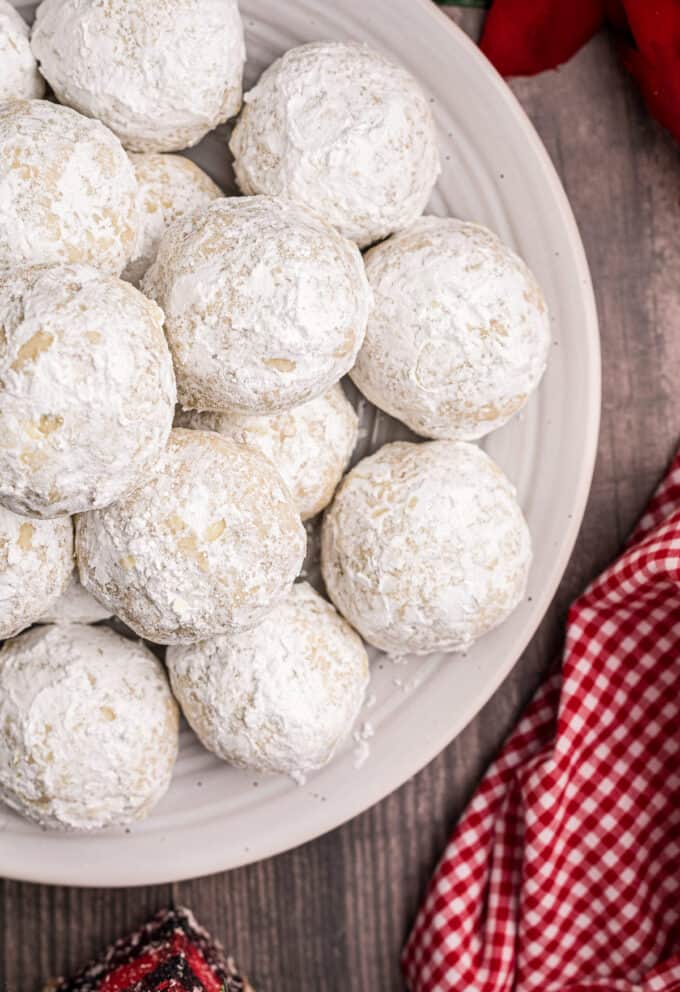 Snowball cookies are a classic holiday dessert made with simple ingredients, are buttery, nutty, and just melt in your mouth. Perfect for Christmas, or any other holiday, they'll be a family favorite on the dessert tray! #cookies #christmas #dessert #baking