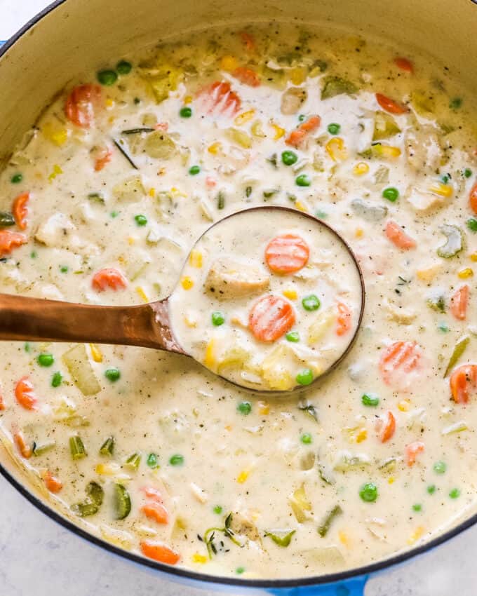 ladle of pot pie soup in dutch oven