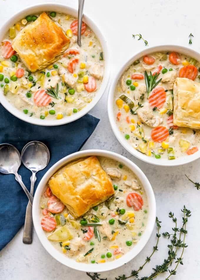 multiple bowls of chicken soup with puff pastry