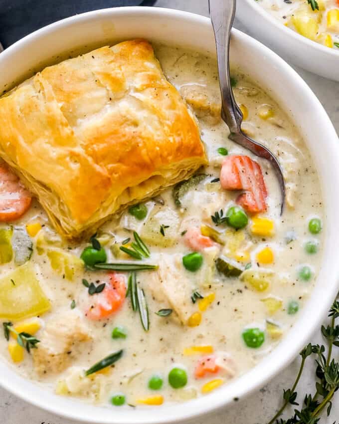 bowl of chicken pot pie soup with spoon
