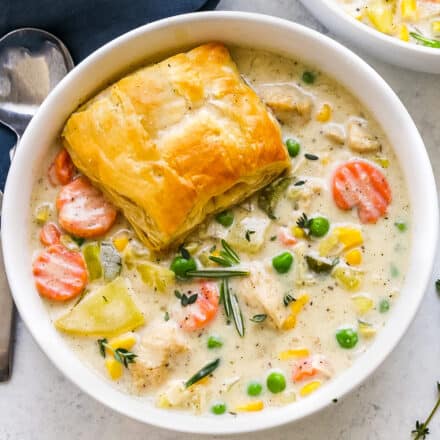 overhead view of a white bowl filled with chicken pot pie soup