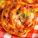 pizza pinwheel with melted cheese and topped with parsley